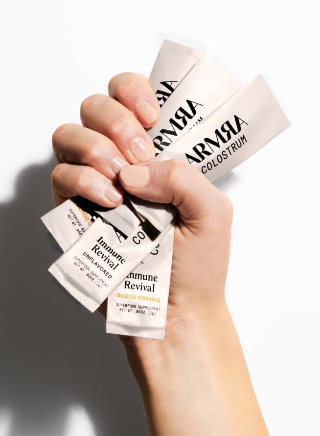 Hand holding ARMRA Sachets