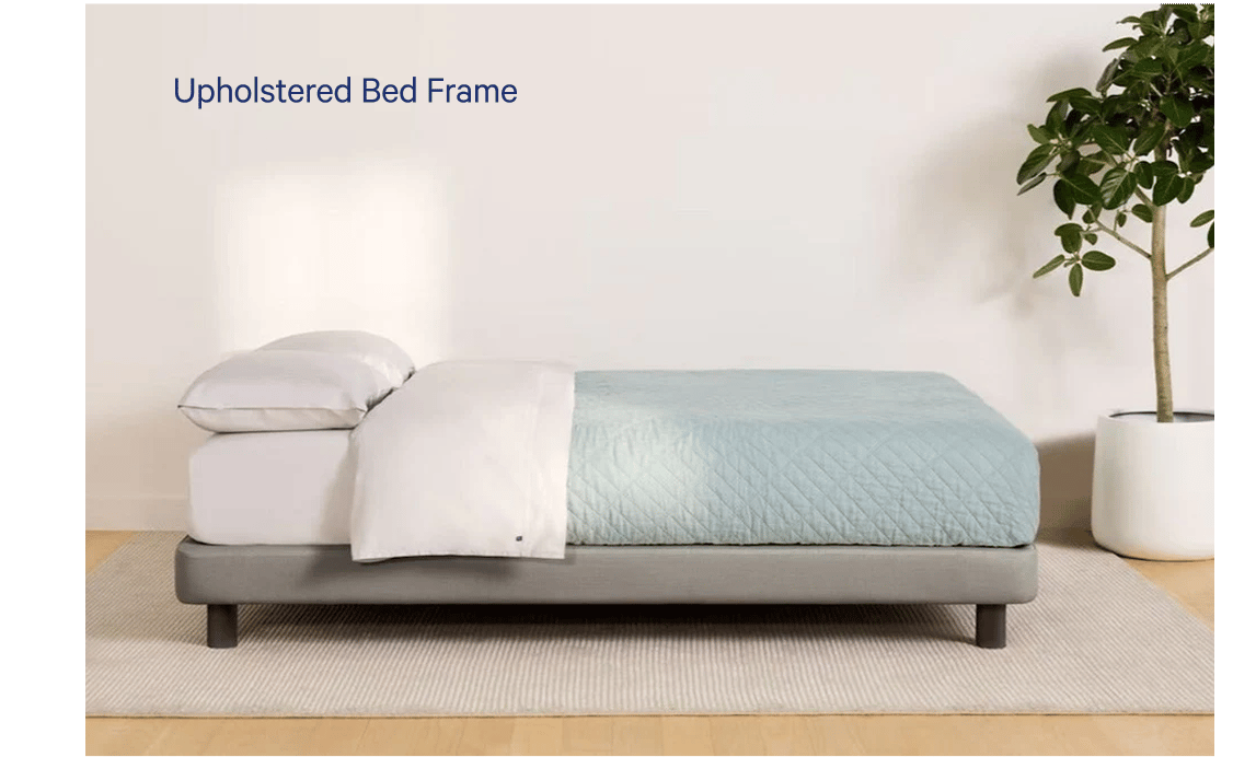 Side view of a fully made bed. The mattress sits atop Casper's Upholstered Bed Frame.