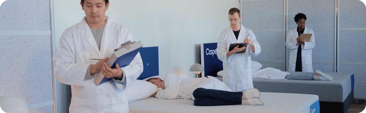 A team of sleep experts in white coats examine patients while they sleep.