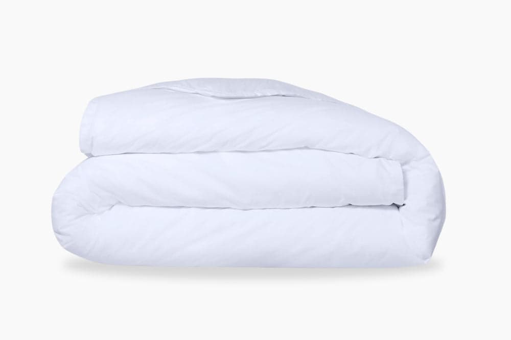 A folded, white duvet cover against a light background