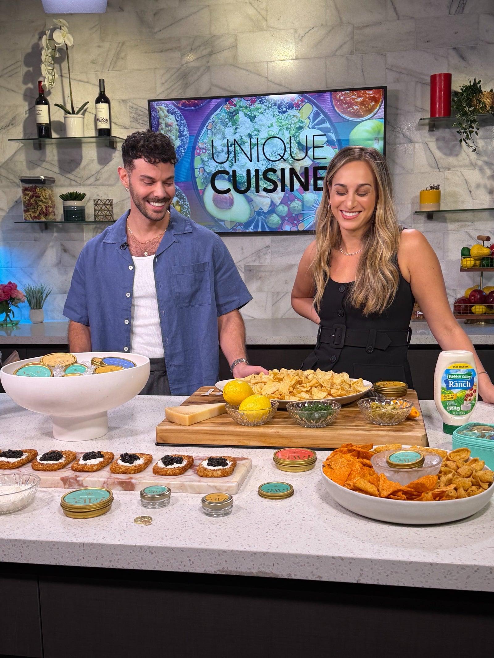 CAVI co-founders Yossi Bibas and Megan Haddad on set with a spread of CAVI caviar