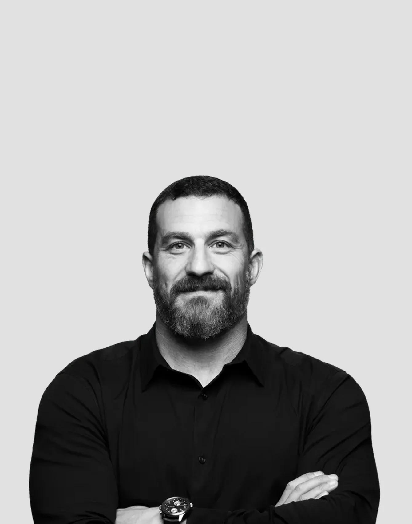 Andrew Huberman, in a black and white studio portrait