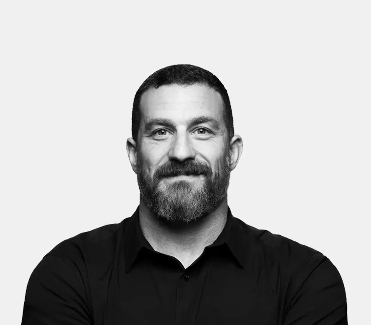 Andrew Huberman, in a black and white studio portrait