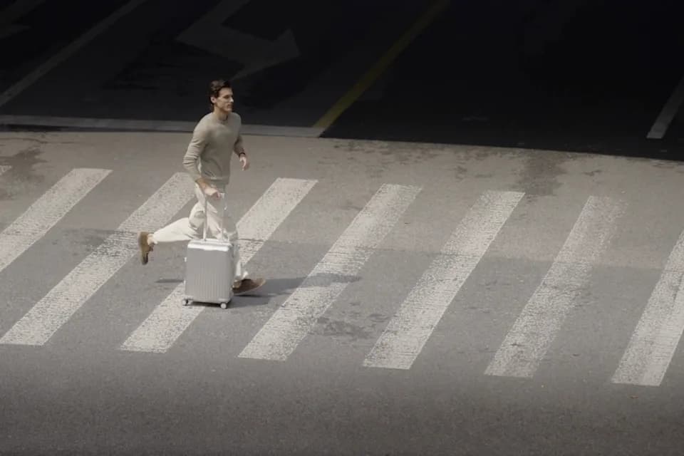 A traveller crossing an airport concourse