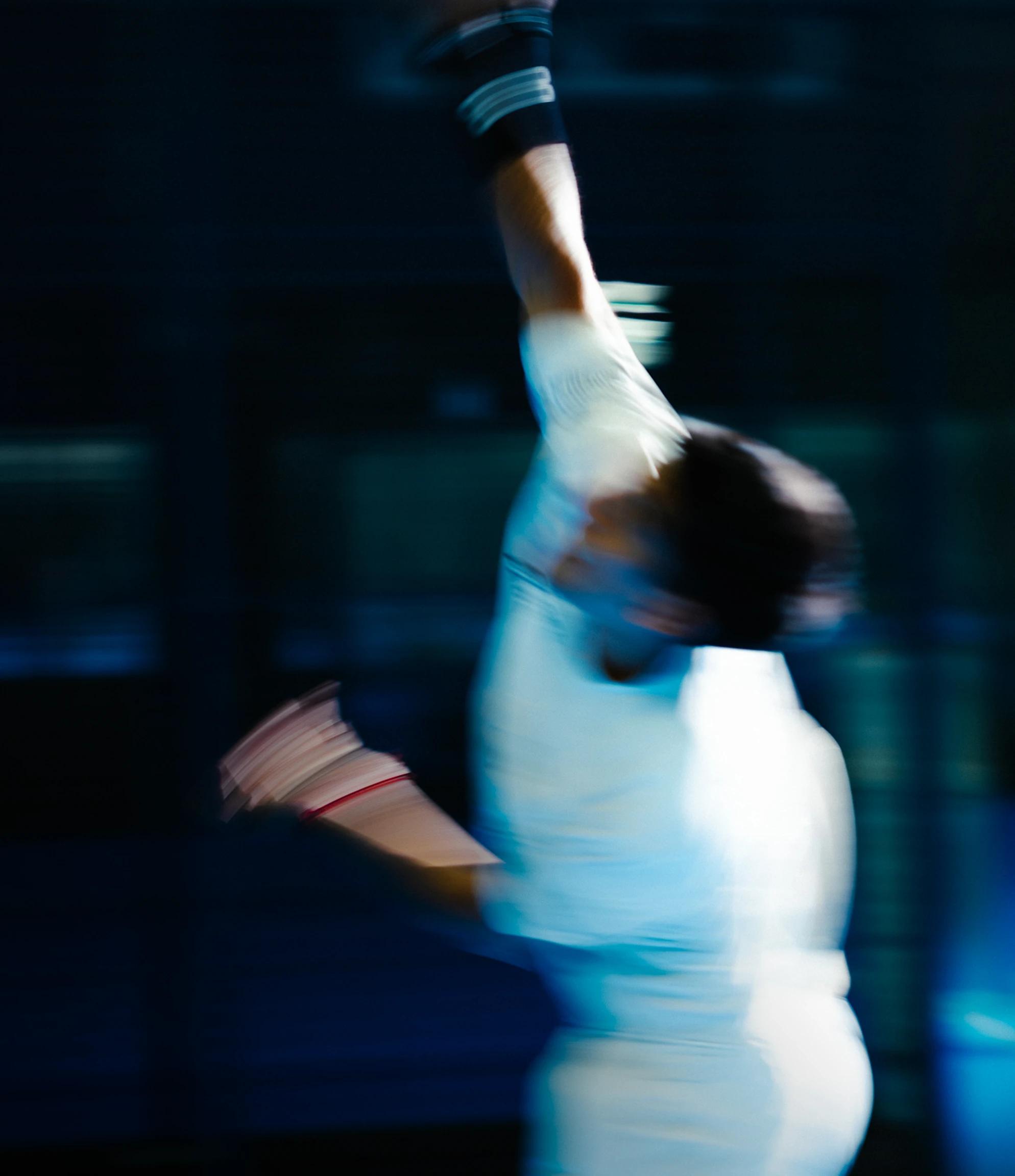 A tennis player mid-serve