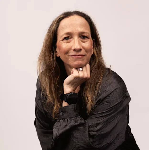 Marni seated, resting her chin on her hand