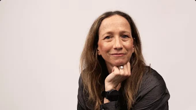 Marni seated, resting her chin on her hand