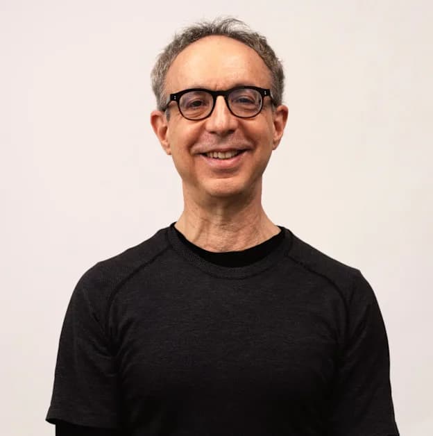 Martin standing in a black tee, smiling