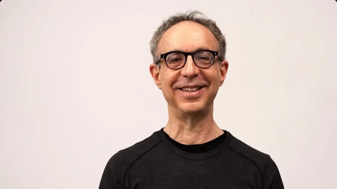 Martin standing in a black tee, smiling