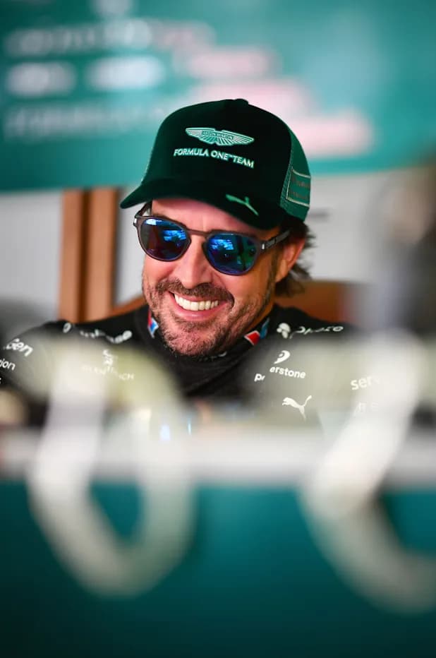 Fernando Alonso in an Aston Martin Aramco cap and team kit