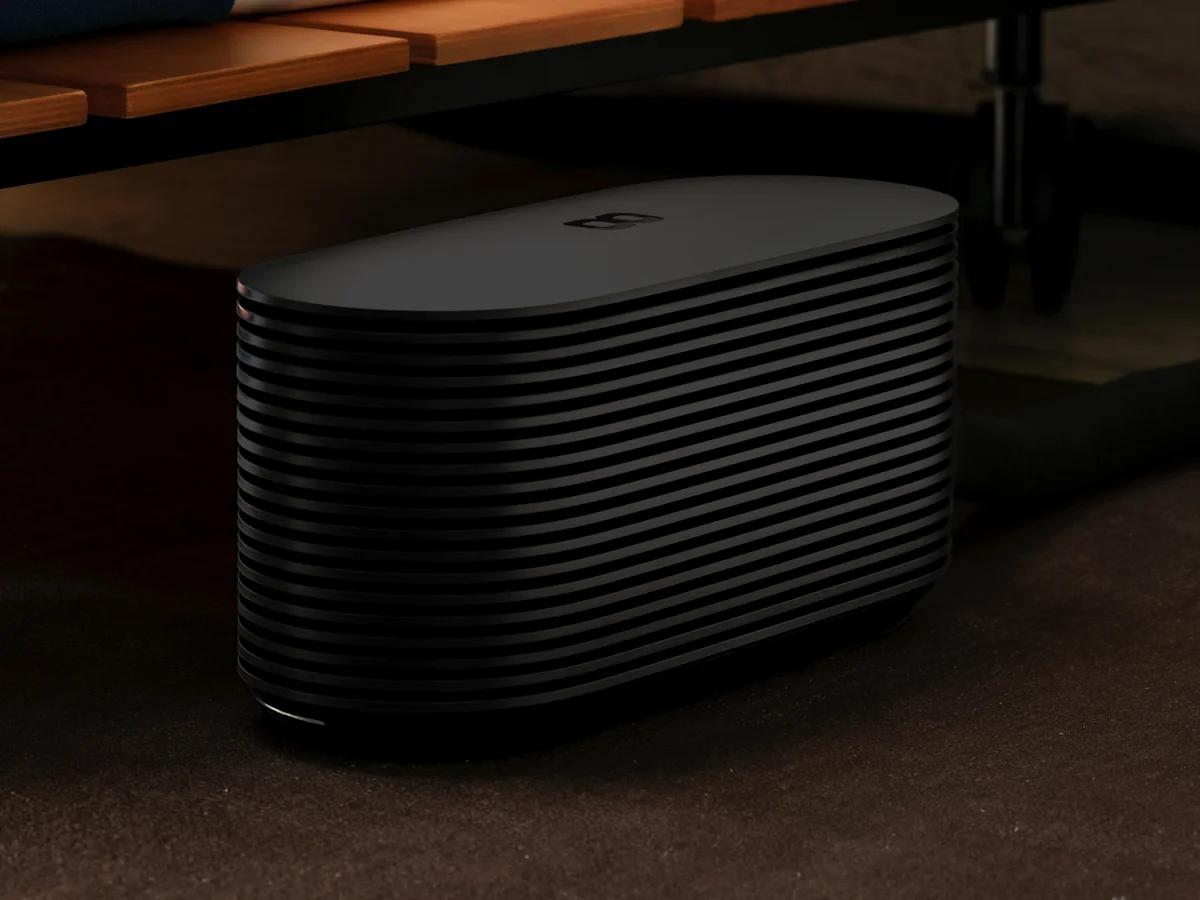 The Pod Hub on the floor beside a bed