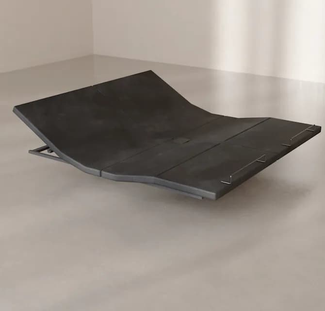 The Base raised at the head and the foot, on a concrete floor