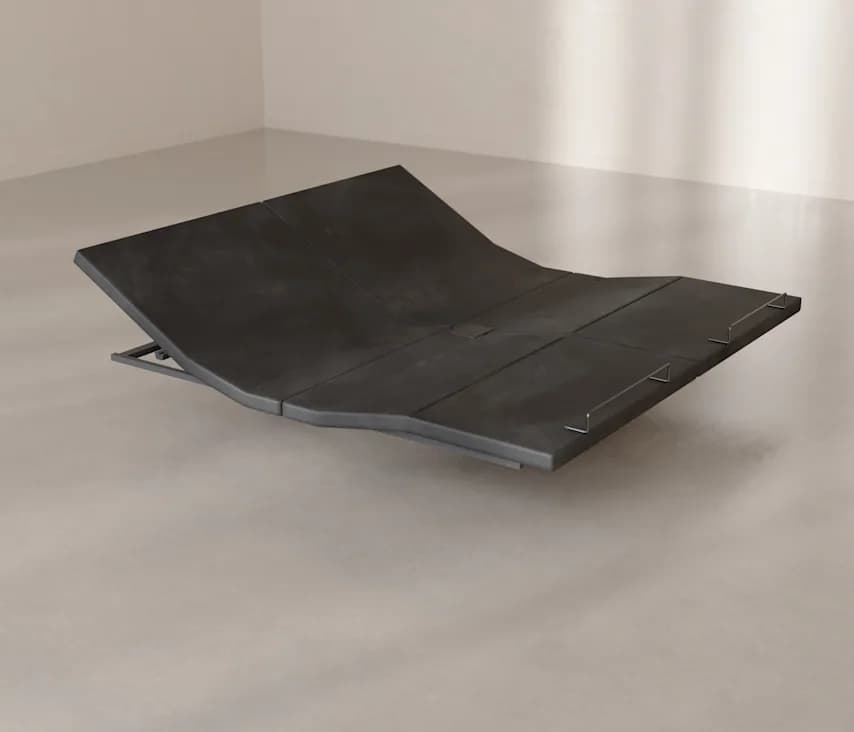 The Base raised at the head and the foot, on a concrete floor
