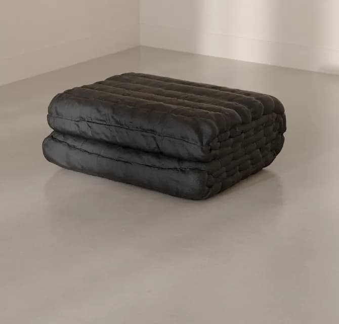 The Blanket folded on a concrete floor