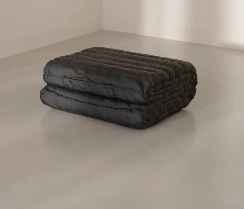 The Blanket folded on a concrete floor