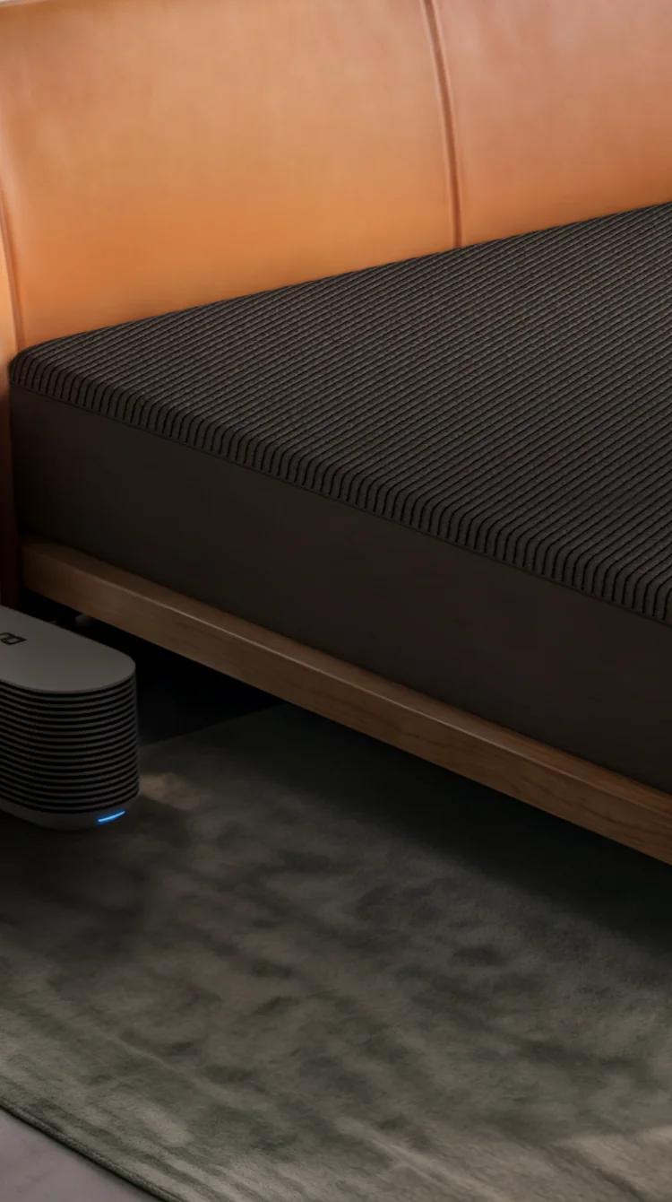 A Pod 6 Cover on a king bed in a bright bedroom, with the Hub on the floor beside it