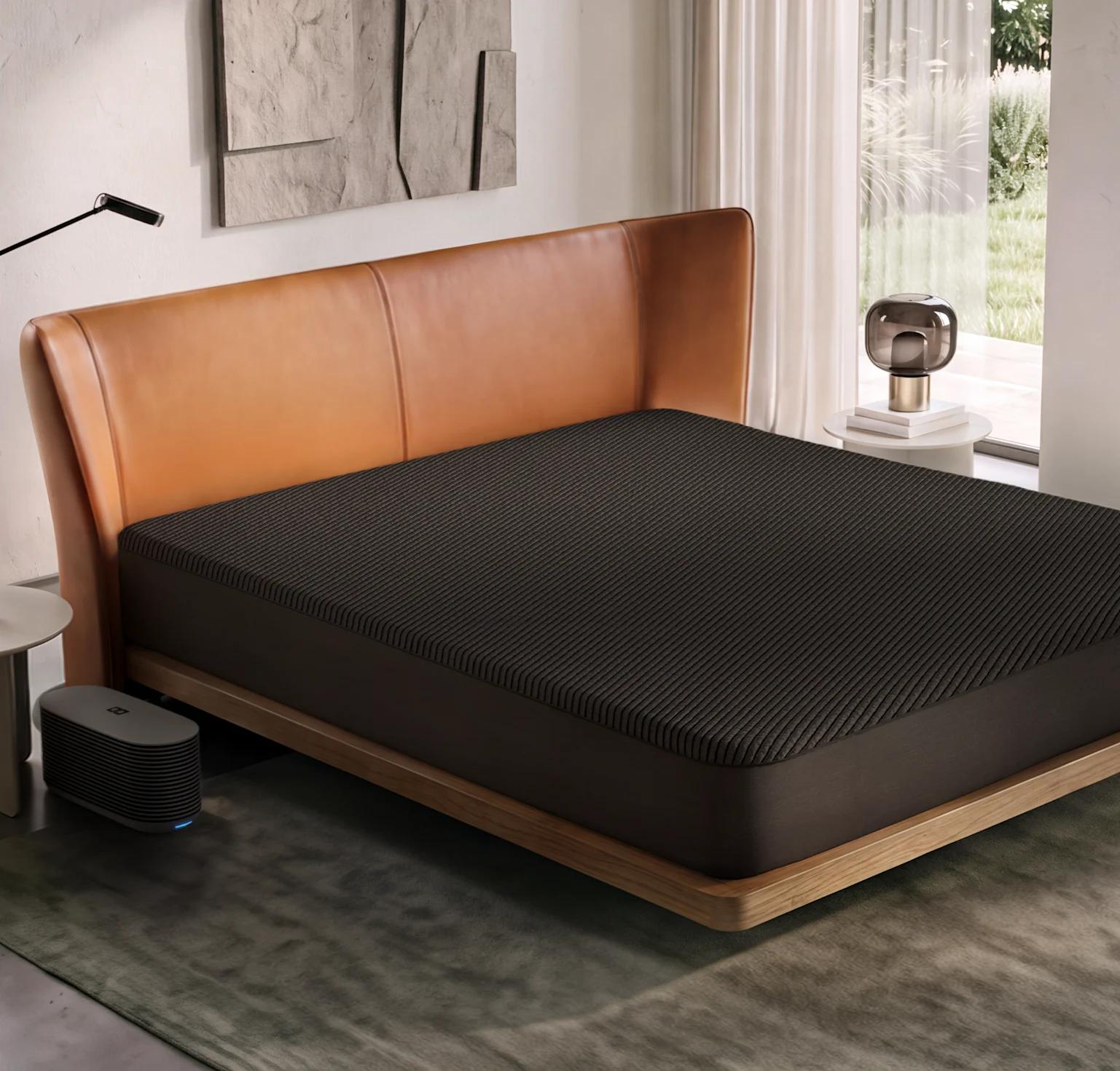 A Pod 6 Cover on a king bed in a bright bedroom, with the Hub on the floor beside it
