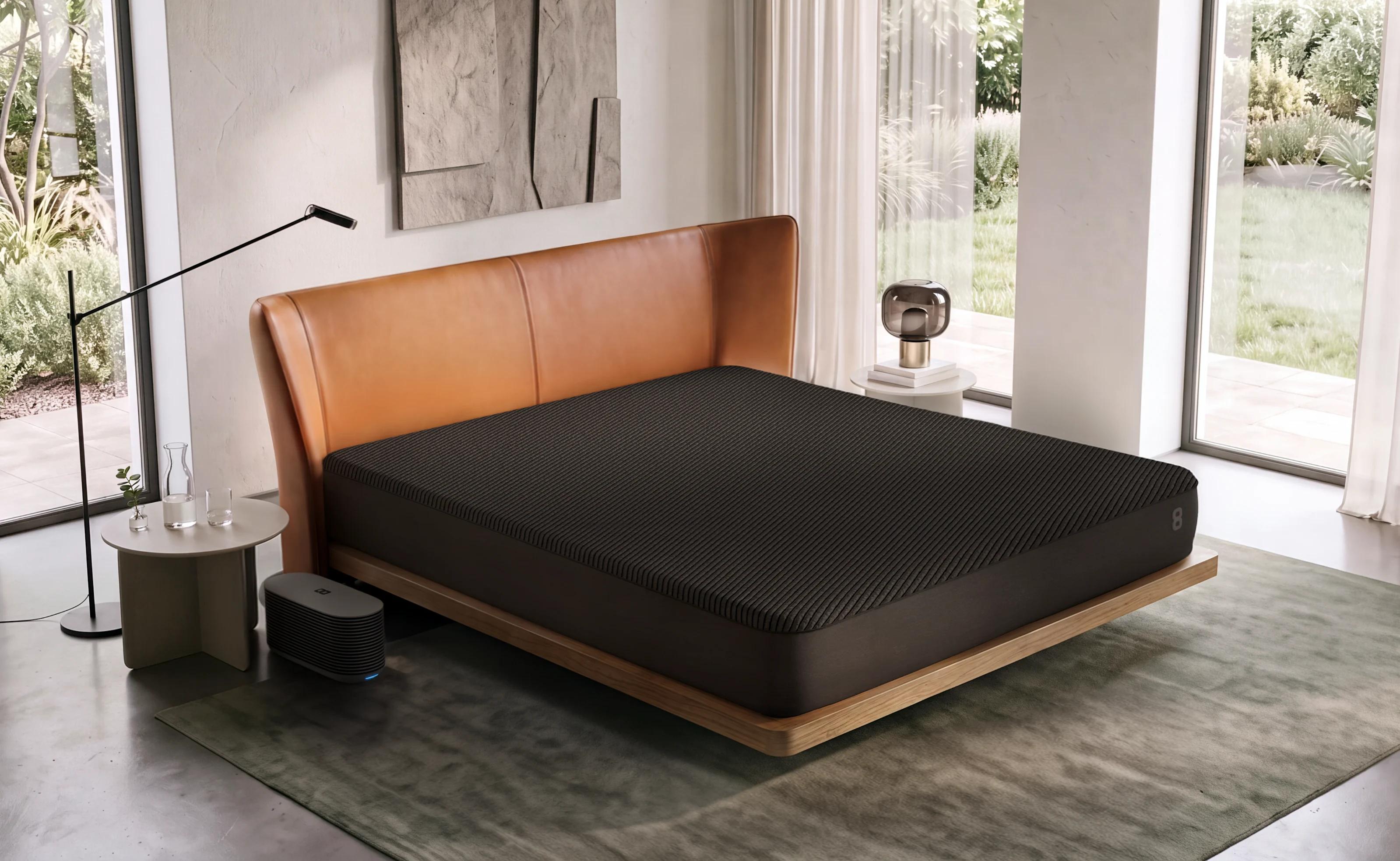 A Pod 6 Cover on a king bed in a bright bedroom, with the Hub on the floor beside it