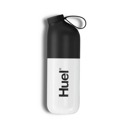 Huel shaker next to two scoops