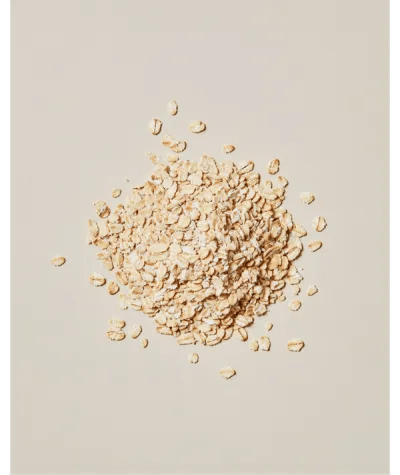 A pile of Oats scattered on a neutral colour background