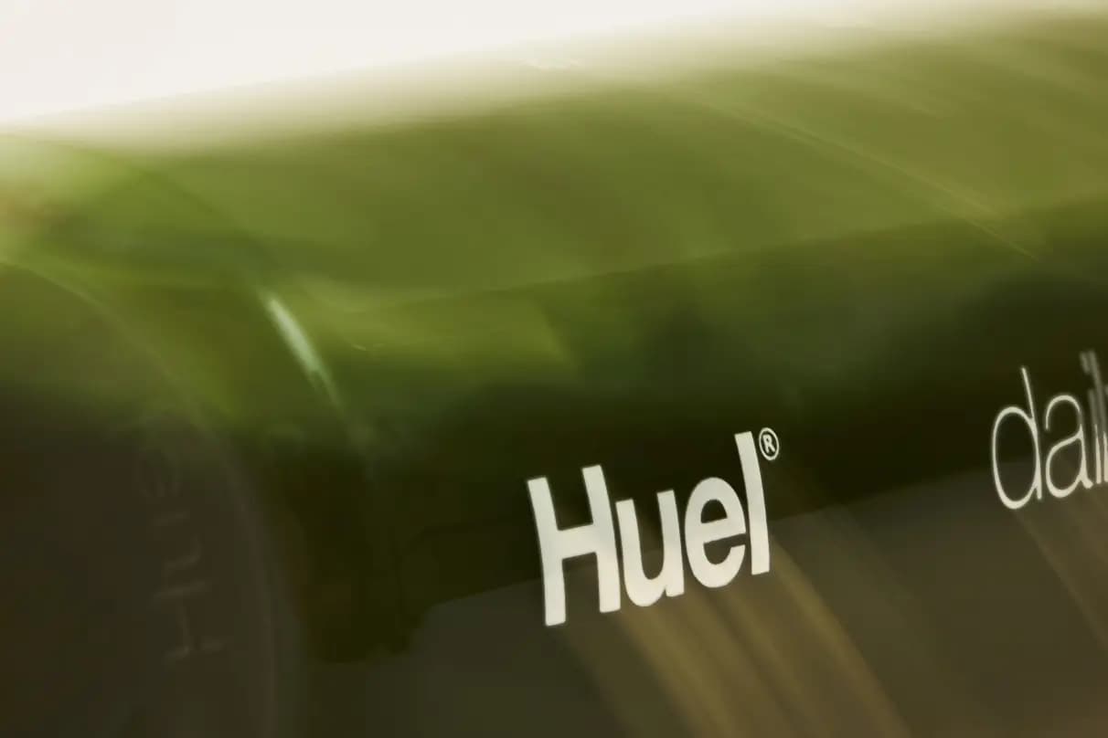 Huel Daily Greens Bottle rolling on its side