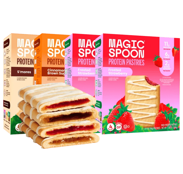 Boxes of Magic Spoon Protein Pastries in assorted flavors with a stack of frosted strawberry pastries