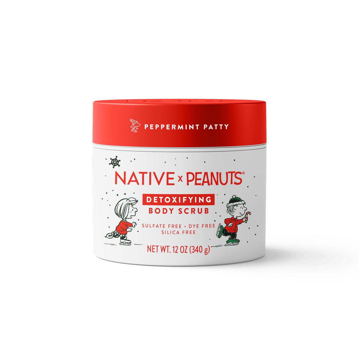 Native x Peanuts Detoxifying Body Scrub in a 12 oz white plastic jar with a bright red lid. The label features Peanuts characters in holiday attire against a white background with light snowflake details.