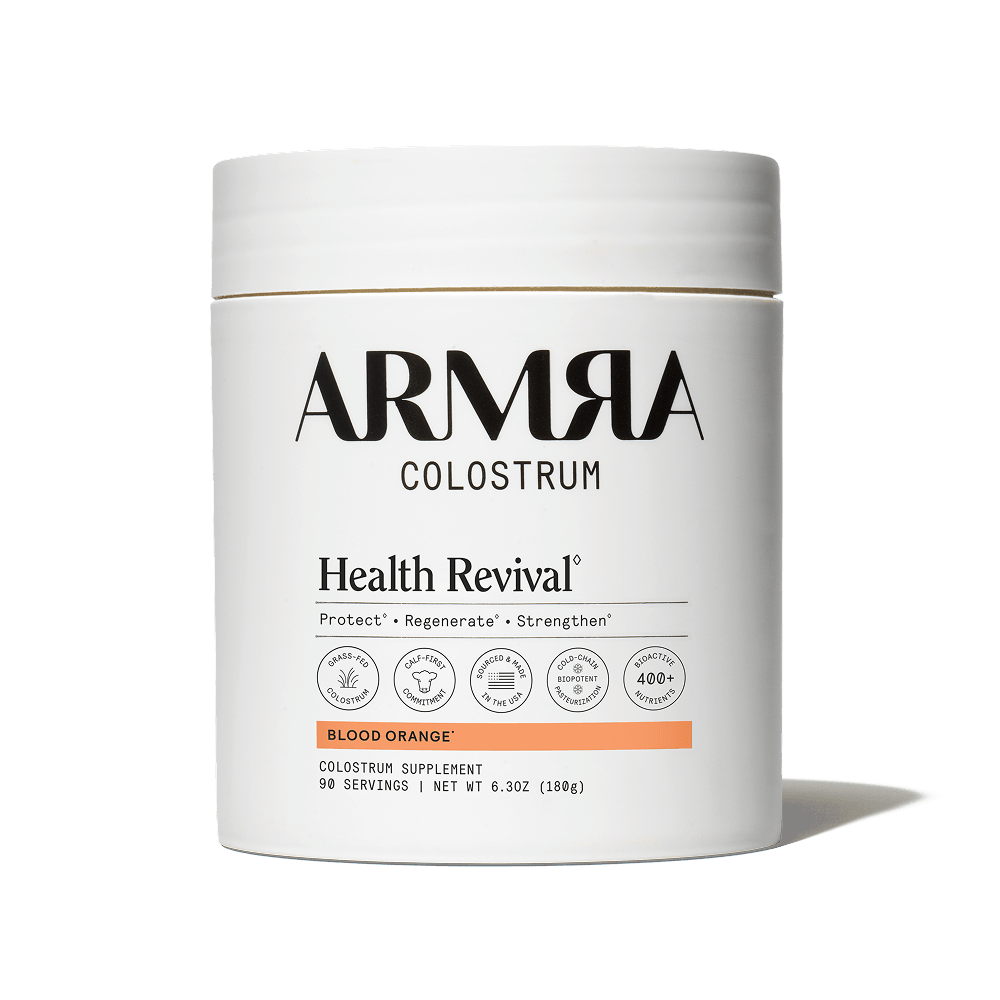 ARMRA Colostrum Health Revival supplement container on a black background