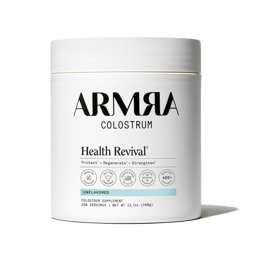 ARMRA Colostrum Health Revival supplement container on a black background