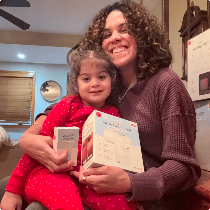 Mom and daughter smiling with a Canopy bath tub filter box