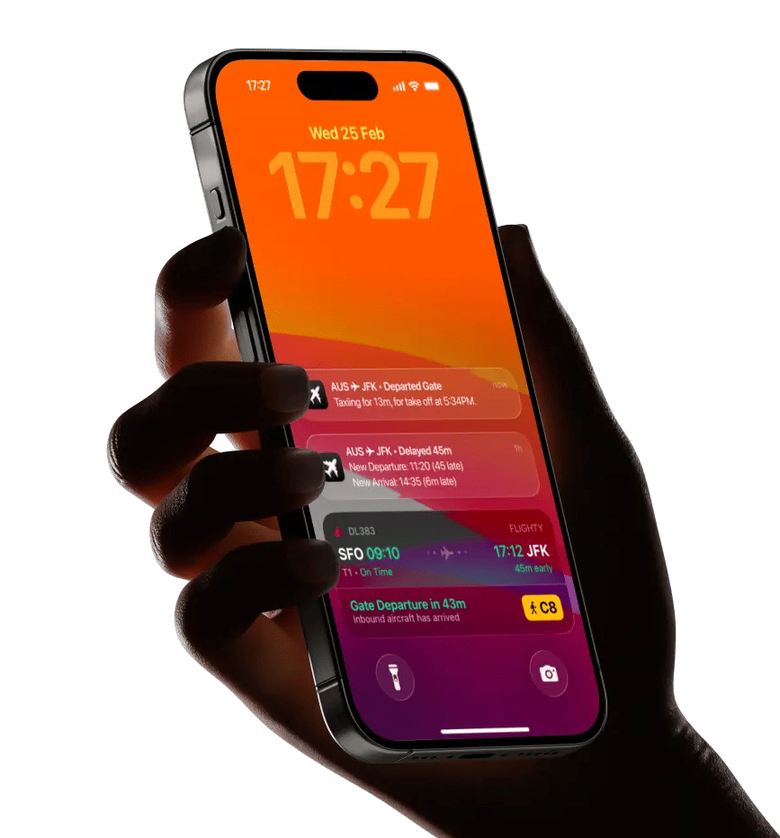 Hand holding iPhone showing Flighty's lock screen with live flight widgets