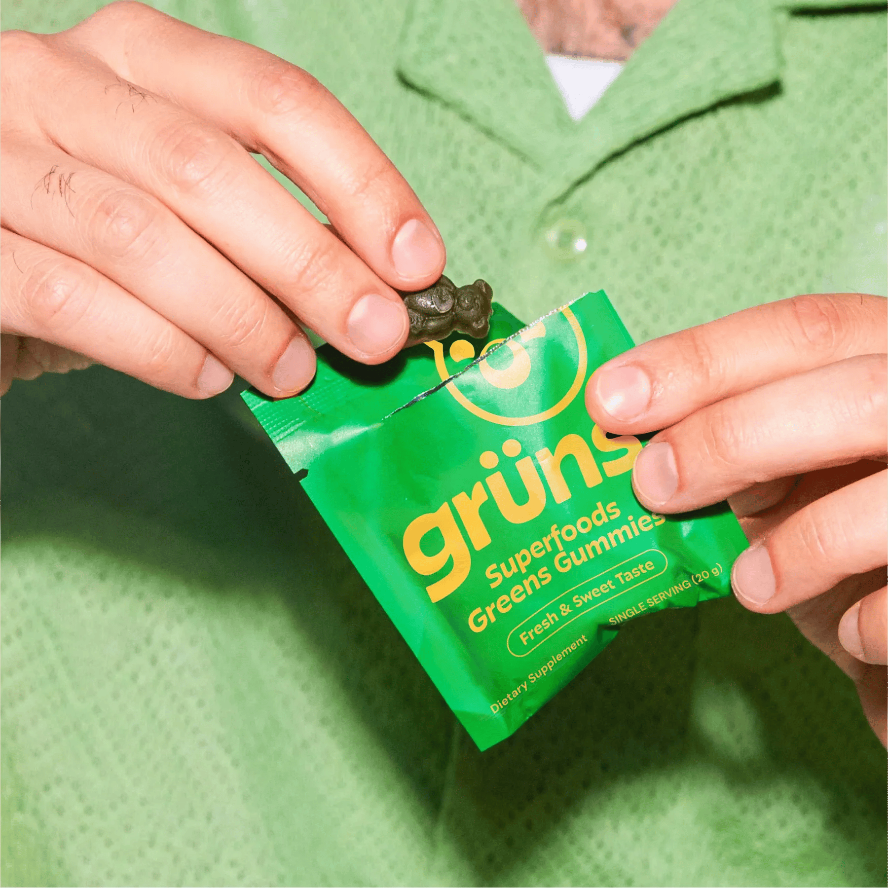 Hand holding Grüns gummy