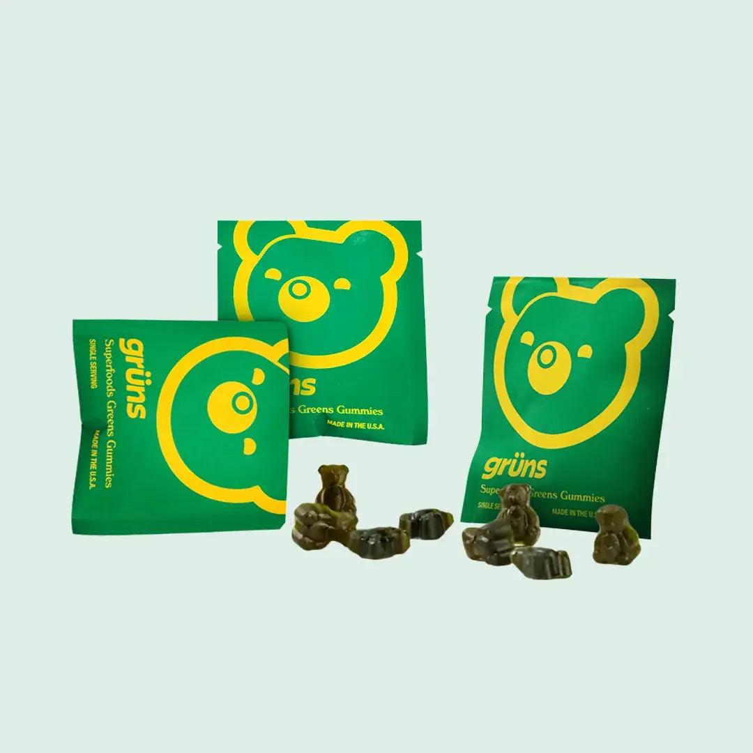 Three Grüns daily packets with green gummy bears poured out in front of them.
