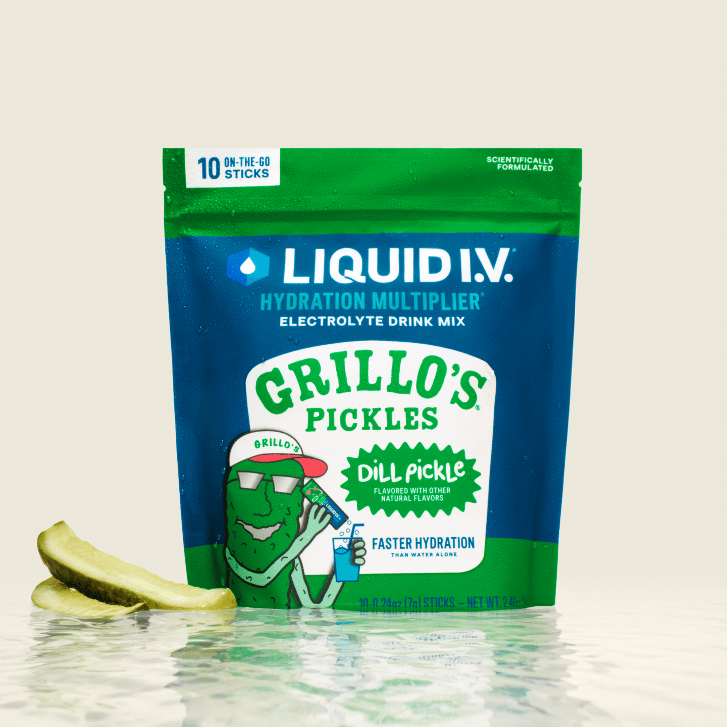 Liquid I.V. Grillo's Pickles Dill Pickle Hydration Multiplier pouch on a reflective water surface with pickle slices