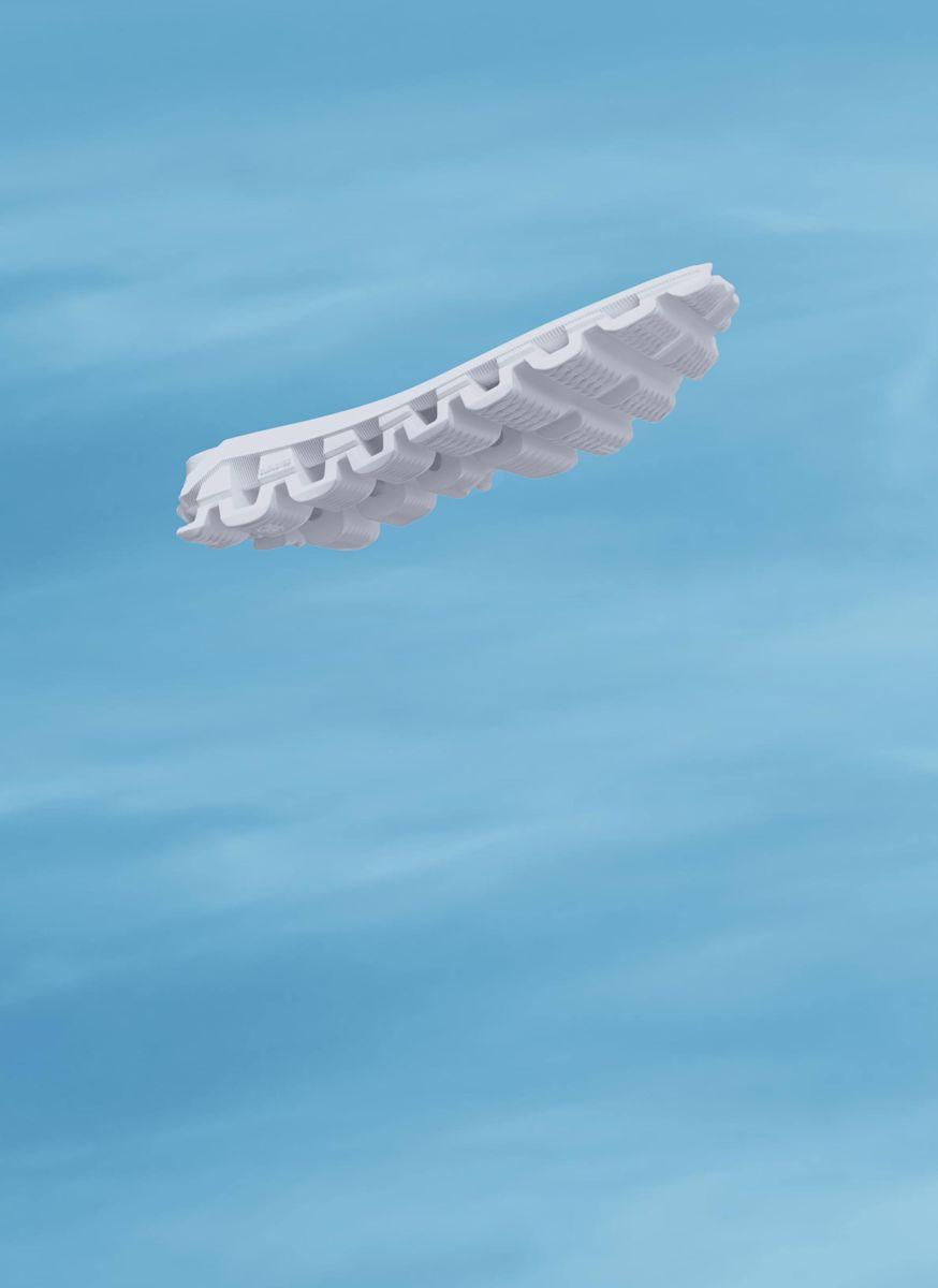 A CloudTec midsole floating in blue sky with light, scattered clouds.
