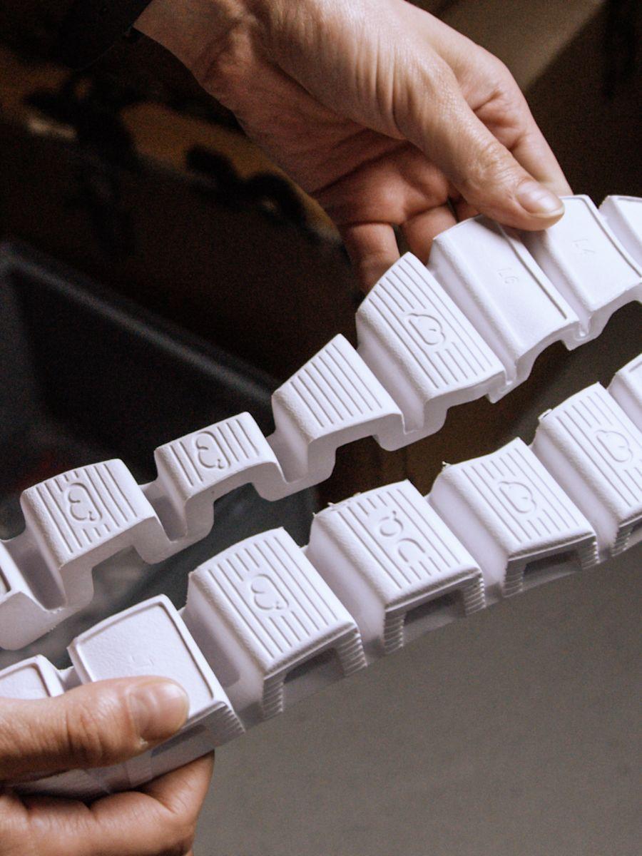 Close up of hands holding a CloudTec outsole.