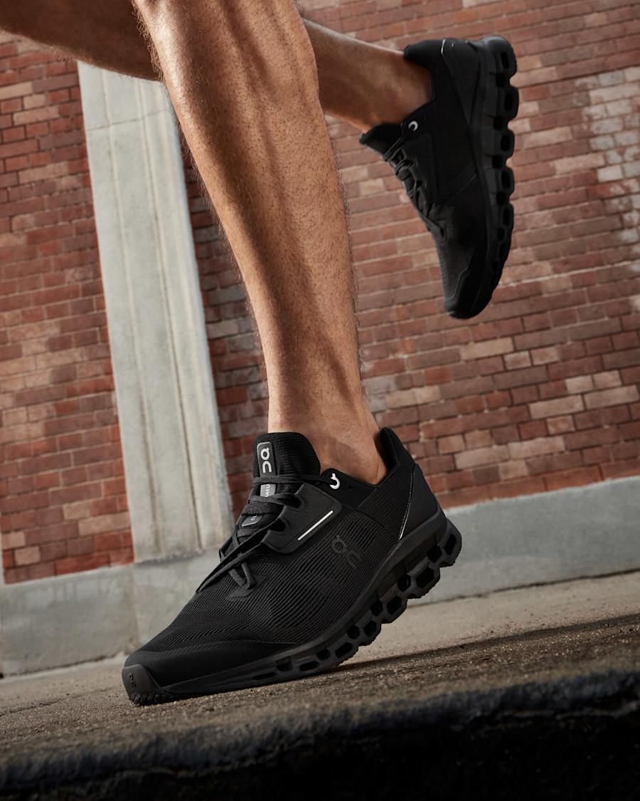 Close-up of On shoe against a brick wall background