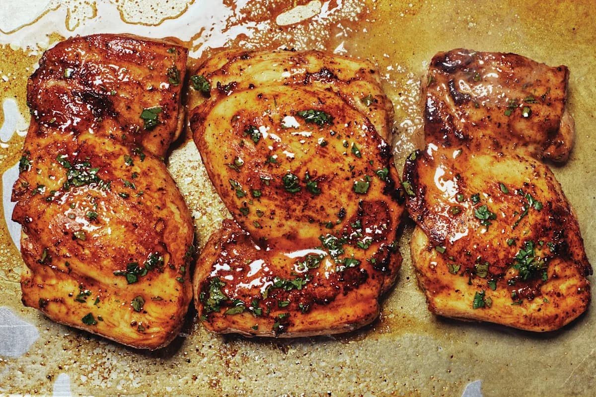 Close-up of roasted chicken thighs seasoned with herbs