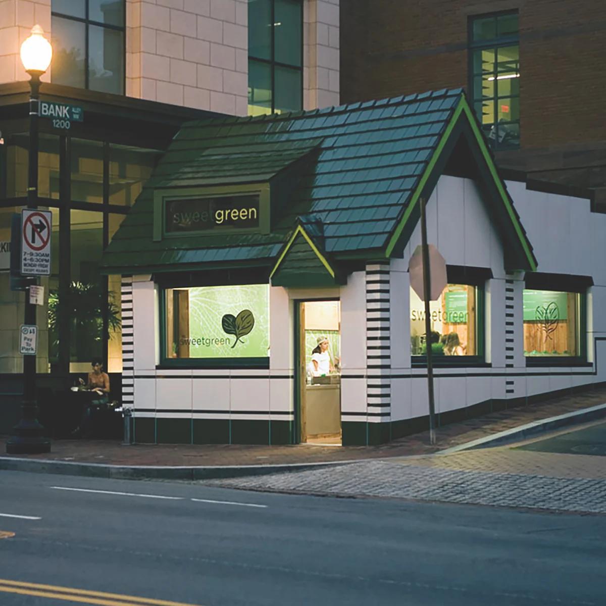 The first sweetgreen store on a Washington DC street corner at dusk